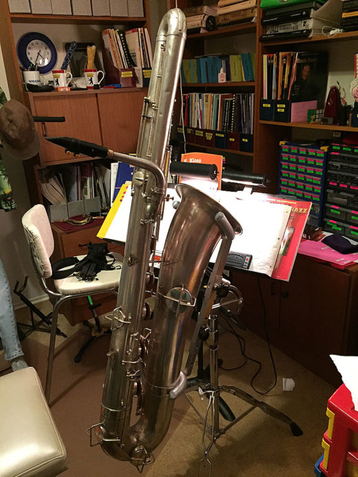 bass in stand Buescher bass sax, True Tone bass saxophone,