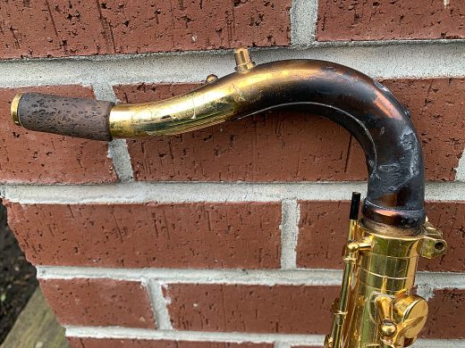 house fire, damaged saxophone neck, charred and burned lacquer, cracked lacquer,
