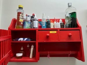 red storage shelf, sampling of oils and other products used in saxophone maintenance, 